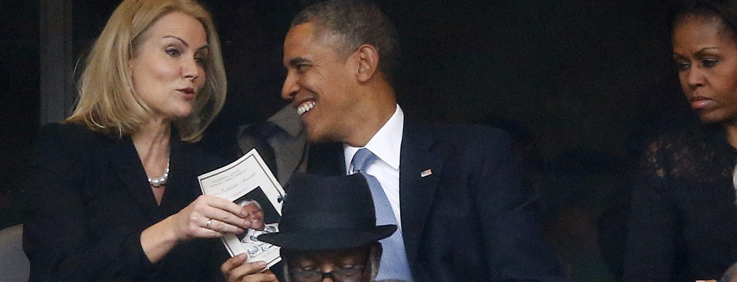 U.S. President Obama shares a laugh with Danish PM Thorning-Schmidt as his wife, U.S. first lady Michelle looks on during a memorial service for late South African President Nelson Mandela in Johannesburg